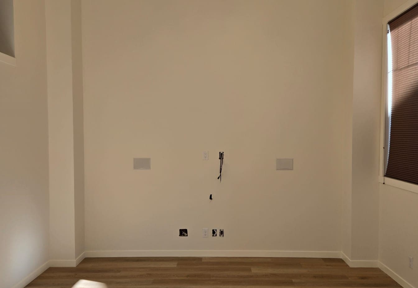The same room after repainting in warm off-white, bright and freshly finished